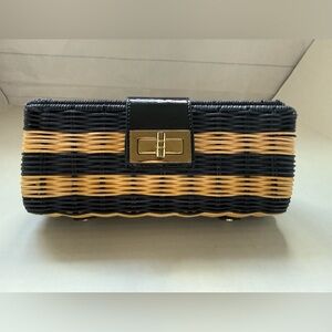 J.Crew wicker clutch in a navy and natural stripe pattern.